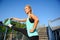 Smiling sportive woman having workout on the steps