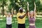 Smiling sports trainer assisting active senior woman in outdoor workout