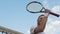 Smiling sportsman with tennis racket raising hand, victory gesture, slow motion