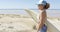 Smiling sporty woman embracing surfboard