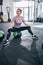 Smiling sporty woman looking away during a seated exercise