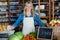 Smiling staff standing in organic section