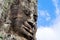 Smiling stone face on tower at Bayon castle