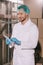 Smiling storekeeper in white coat and