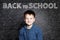 Smiling Student child thinking on chalkboard with math formulas