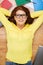 Smiling student in eyeglasses lying on floor