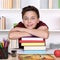 Smiling student on a stack of books at school