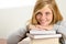 Smiling student teenager leaning head on books