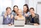 Smiling students with laptop showing thumbs up