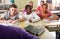 Smiling students sitting at their desks in classroom