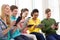 Smiling students with tablet pc at school