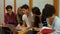 Smiling students using laptop in locker room