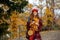 smiling stylish 40 years old woman in red hat walking