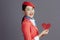 smiling stylish asian female air hostess against gray