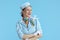 smiling stylish female air hostess on blue
