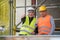 Smiling and successful construction workers posing showing thumbs up gesture