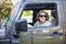 Smiling and successful happy adult woman driving a car. Sitting in the driver`s seat after leaving the dealership