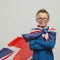 Smiling superhero boy with British flag cape