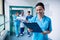 Smiling surgeon holding a clipboard at hospital