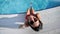 Smiling tanned girl in bikini enjoying vacation swimming pool having fun looking at camera