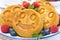 Smiling tasty corn pancake with berries, close-up