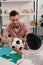 smiling teacher and african american preschooler holding soccer ball together