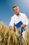 Smiling technician controls wheat field