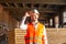 Smiling technician employee holding white hard hat