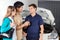 Smiling Technician Taking Car Keys From Couple