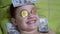 Smiling Teen Boy Lies, on a Bed with Dollars, Gold Bitcoins on Eyes. Humor. 4K