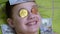 Smiling Teen Boy Lies, on a Bed with Dollars, Gold Bitcoins on Eyes. Humor. Zoom