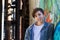 Smiling teen boy next to graffiti painted wall.