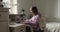 Smiling teen girl in headset greeting classmates at online lecture.