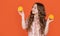 smiling teen girl hold citric fruit on orange background