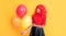 smiling teen girl with party balloon on yellow background