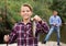 Smiling teenage boy holding catch freshwater fish