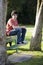 Smiling Teenage Boy Sitting on Bench