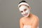 Smiling teenage girl cosmetics mask skin beauty