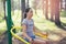 Smiling teenage girl does exercises at massager simulator