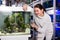 Smiling teenage girl is looking at striped and colorful fishes