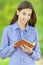 Smiling teenage girl reading orange book