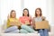 Smiling teenage girls with cardboard boxes at home