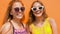 Smiling teenage girls in sunglasses outdoors