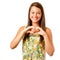 Smiling teenager girl making heart shape