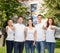 Smiling teenagers in t-shirts showing thumbs up