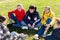 Smiling teenages discussing on green grass