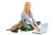 Smiling teengirl sitting on floor and using laptop