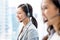 Smiling telemarketing Asian woman in call center