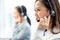 Smiling telemarketing Asian woman working in call center