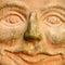 Smiling terracotta face